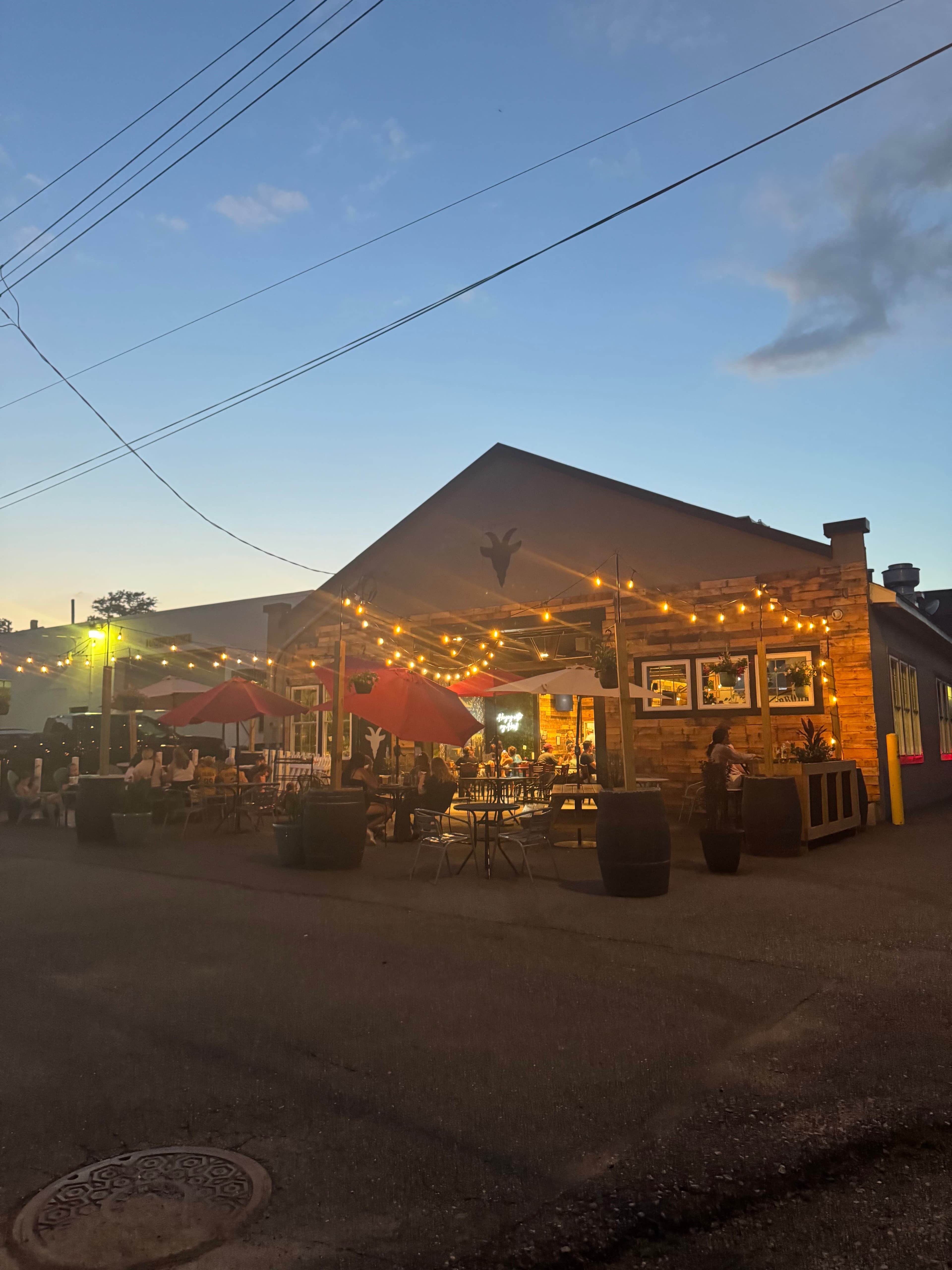Stubborn Goat Brewing exterior at sunset with outdoor patio
