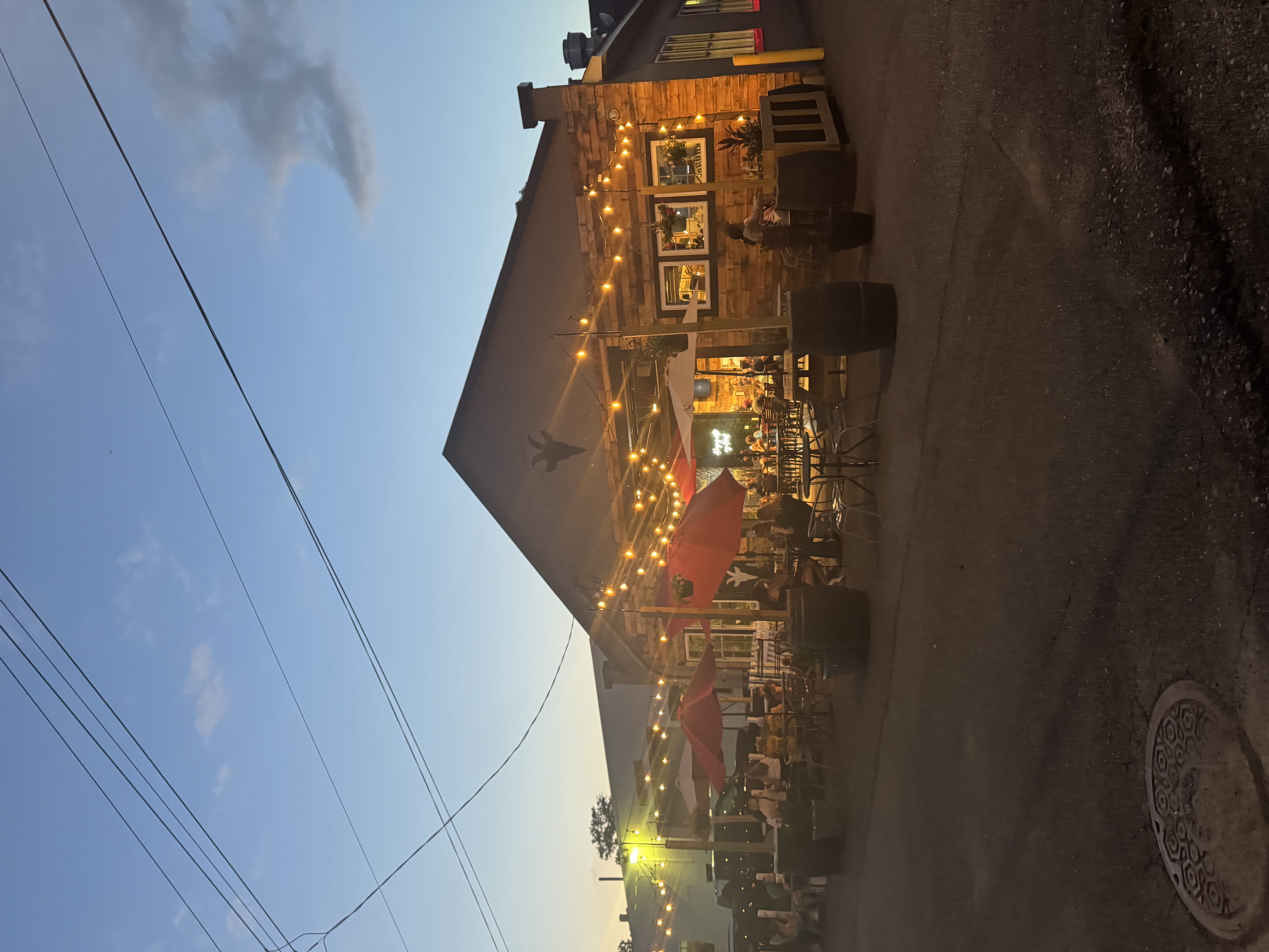 Stubborn Goat Brewing exterior at sunset with outdoor patio